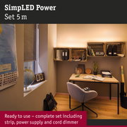 Modern workspace with wooden desk, grey chair, and wooden wall shelves illuminated by warm lighting