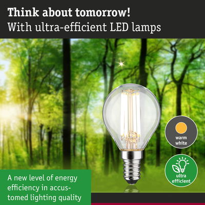 Energy-efficient LED lamp with warm white light against green forest background for eco-friendly lighting
