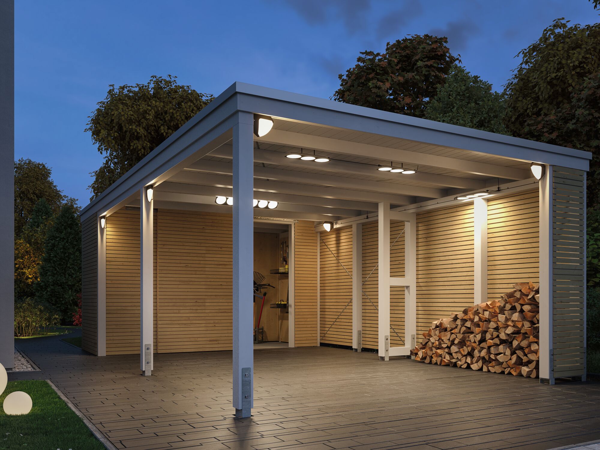 Illuminated white wooden carport with modern LED outdoor lights and stacked firewood in garden.