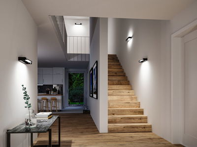 Modern hallway with wooden stairs and black LED wall lights providing ambient home lighting