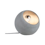 Round table lamp made of grey concrete with visible bulb and fabric cable for modern lighting