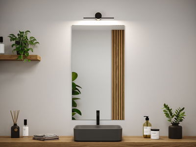 Modern bathroom with black sink, wooden countertop, and minimalist mirror light fixture