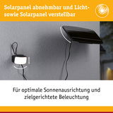 Schwarzes, verstellbares Solarpanel und Licht an grauer Wand für optimale Sonnenausrichtung und Beleuchtung