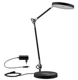 Modern black LED desk lamp with round light head and adjustable arm made of metal and plastic.