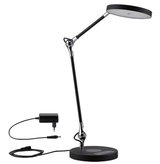 Lampe de bureau LED noire moderne avec tête ronde et bras réglable en métal et plastique.