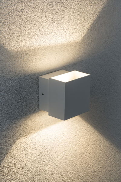 Modern white aluminum wall light with warm white illumination for stylish indoor lighting
