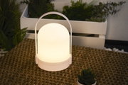 White LED table lamp with warm light on woven table, modern indoor lighting for home