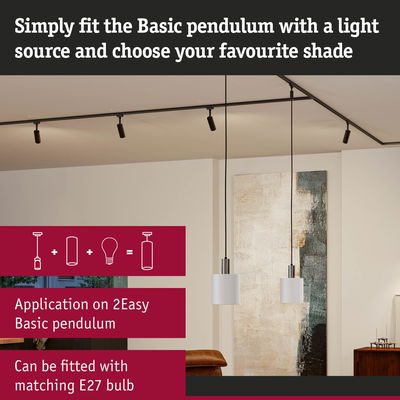 Two white metal Basic pendant lights with black cords in modern living room featuring abstract wall art