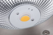 Close-up of LED reflector with silver aluminium surface and yellow light source core