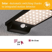 Black solar LED light with integrated motion sensor and 120° detection angle for outdoor use