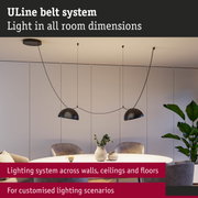 Modern ULine lighting system with black pendant lamps above round dining table in living room