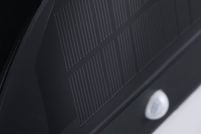 Close-up of black glass ceramic cooktop with fine white lines and control panel visible.