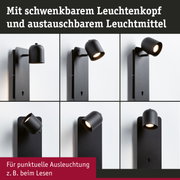 Schwarze Wandlampe mit schwenkbarem Leuchtenkopf für punktuelle Beleuchtung beim Lesen