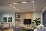 Modern living room with square warm white LED ceiling light, wooden shelves, and green carpet.