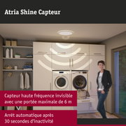 Plafonnier blanc Atria Shine avec capteur dans une buanderie moderne avec lave-linge et sèche-linge