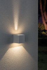 Modern white aluminum wall light with warm white illumination for outdoor use.