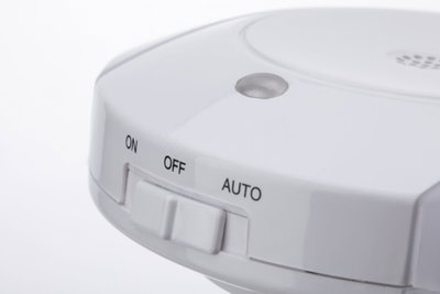 White plastic switch with On, Off, and Auto settings for electronic devices.