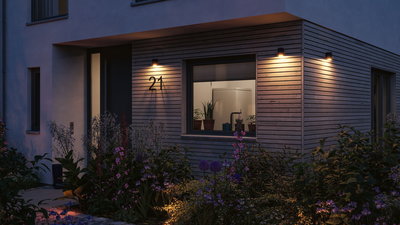 Modern outdoor lighting with warm white light on wooden facade and house number 21 in garden area