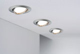Three adjustable recessed spotlights in brushed aluminum mounted in ceiling for modern room lighting