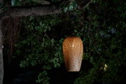 Brown woven wood hanging outdoor lamp with warm light for garden lighting and decor