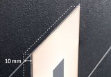 Close-up of black wall with illuminated rectangular LED panel showing 10 mm gap detail.