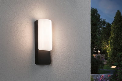 Modern outdoor wall light with black metal frame and white glass, warm illumination for garden and patio