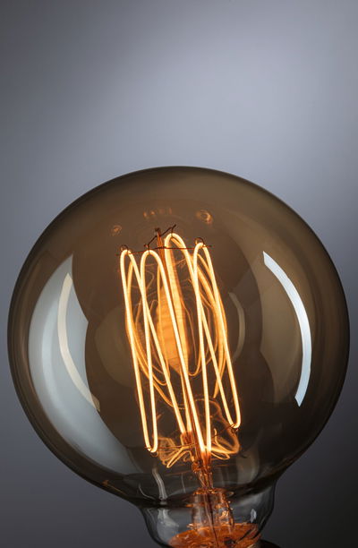 Close-up of a warm glowing glass filament bulb for decorative lighting and ambient atmosphere