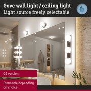 G9 wall light with white glass globes in modern bathroom featuring mirror and sink.