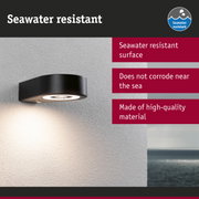 Black metal wall light with seawater resistant surface for outdoor lighting near the sea