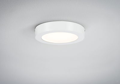 Round white metal LED ceiling light with diffused illumination for modern interiors