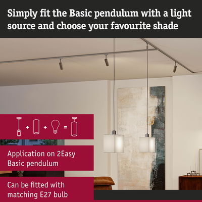 Two white glass pendant lights with metal fittings in modern living room with abstract wall art