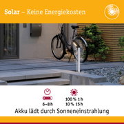 Solarbetriebene Außenleuchte neben schwarzem Fahrrad vor modernem Haus mit Betonboden