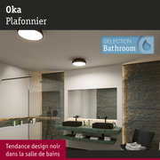 Salle de bains moderne avec plan de travail en marbre vert, vasques noires et plafonniers ronds design
