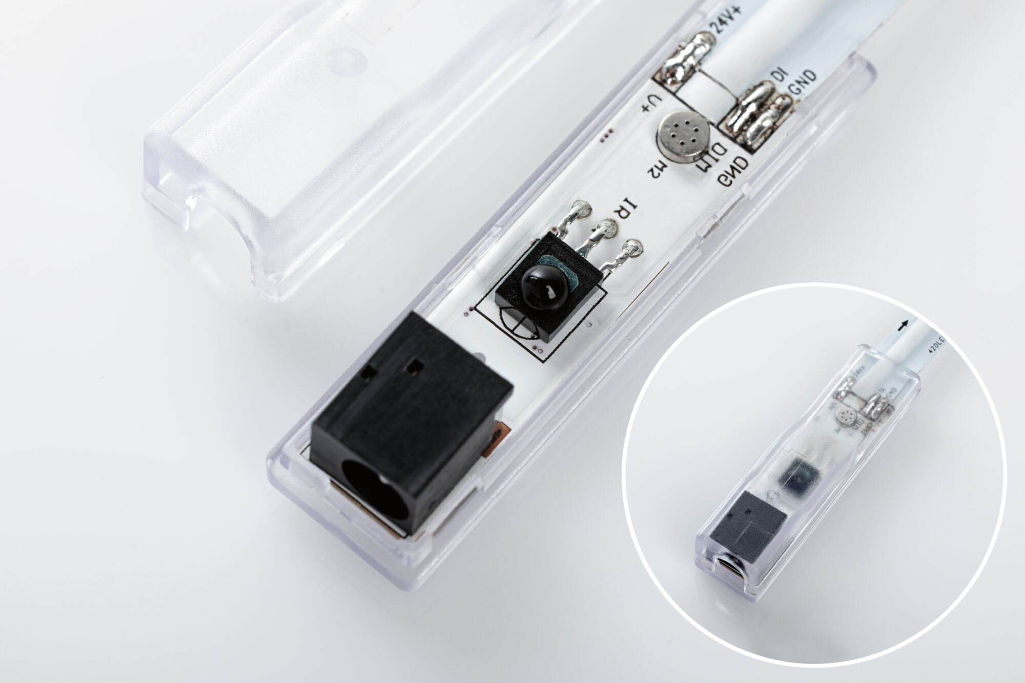 Electronic LED module with transparent plastic housing and black connector for lighting technology