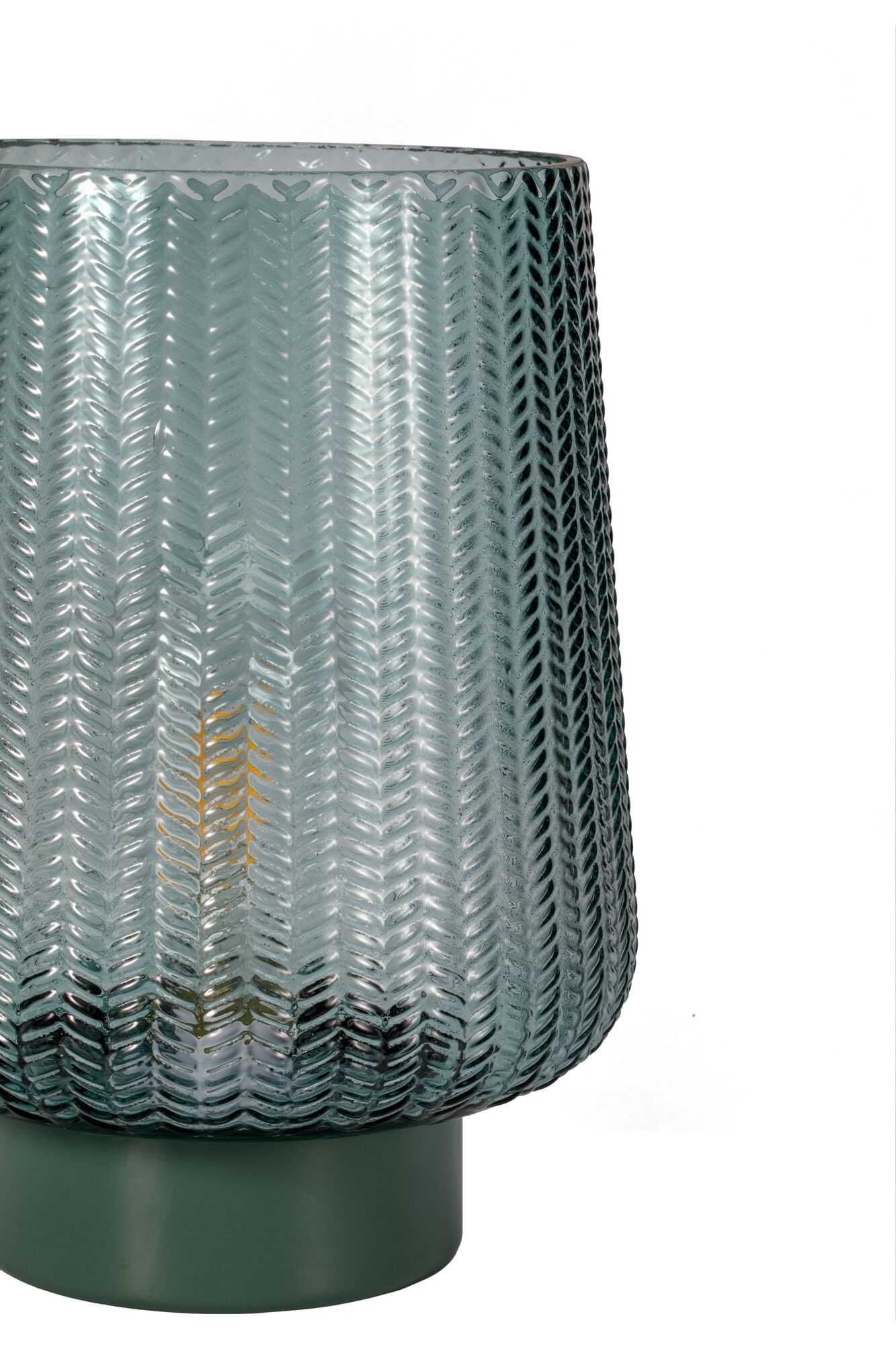 Glass lantern with green base and textured pattern for ambient lighting in home decor