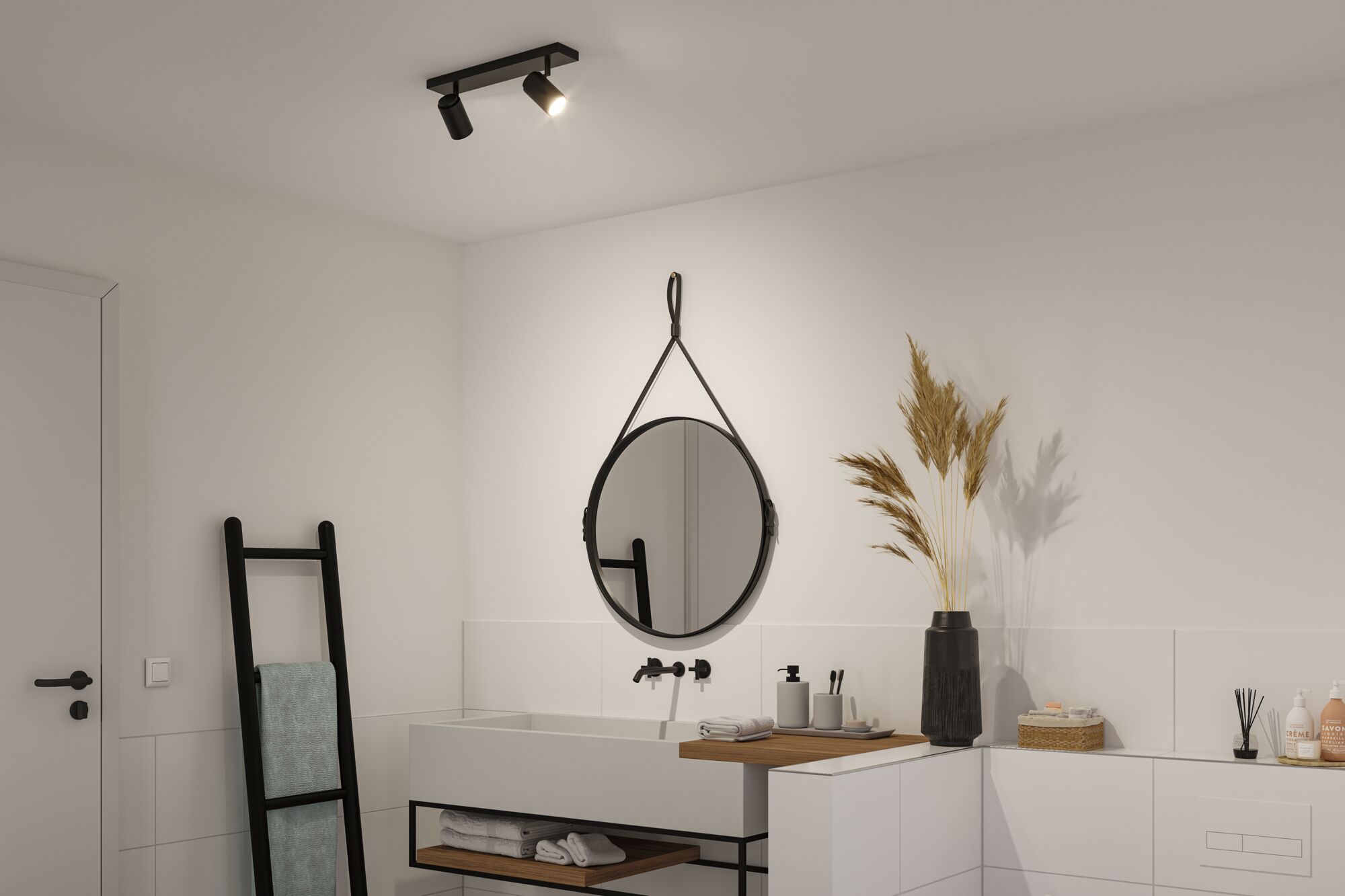 Modern bathroom with black ceiling light, round mirror, and white sink with wooden shelf