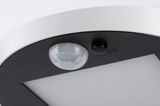 Close-up of white and black LED ceiling light with motion sensor and on/off switch