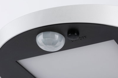 Close-up of white and black LED ceiling light with motion sensor and on/off switch
