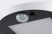 Close-up of white and black LED ceiling light with motion sensor and on/off switch