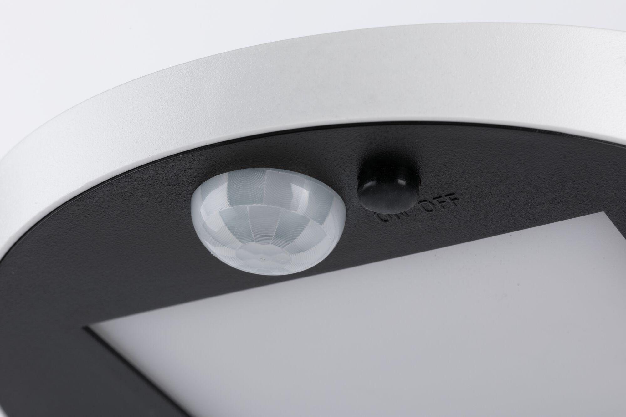 Close-up of white and black LED ceiling light with motion sensor and on/off switch