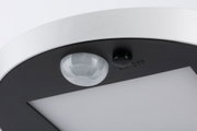 Close-up of white and black LED ceiling light with motion sensor and on/off switch
