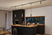 Modern kitchen with black wood finish, wooden countertop, pendant lights, and bar stools in dining area