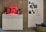Rotes LED-Leuchtbuchstabe F auf weißem Sideboard mit Marmorplatte, moderne Wohnraumbeleuchtung.