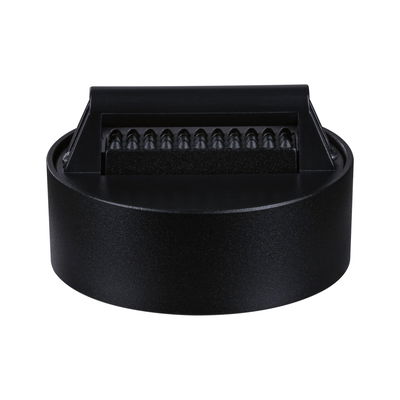 Round black LED light with textured plastic diffuser for modern indoor lighting solutions