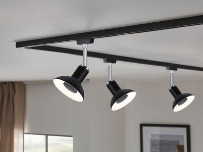 Black metal LED ceiling spotlights with adjustable heads on track system for living spaces
