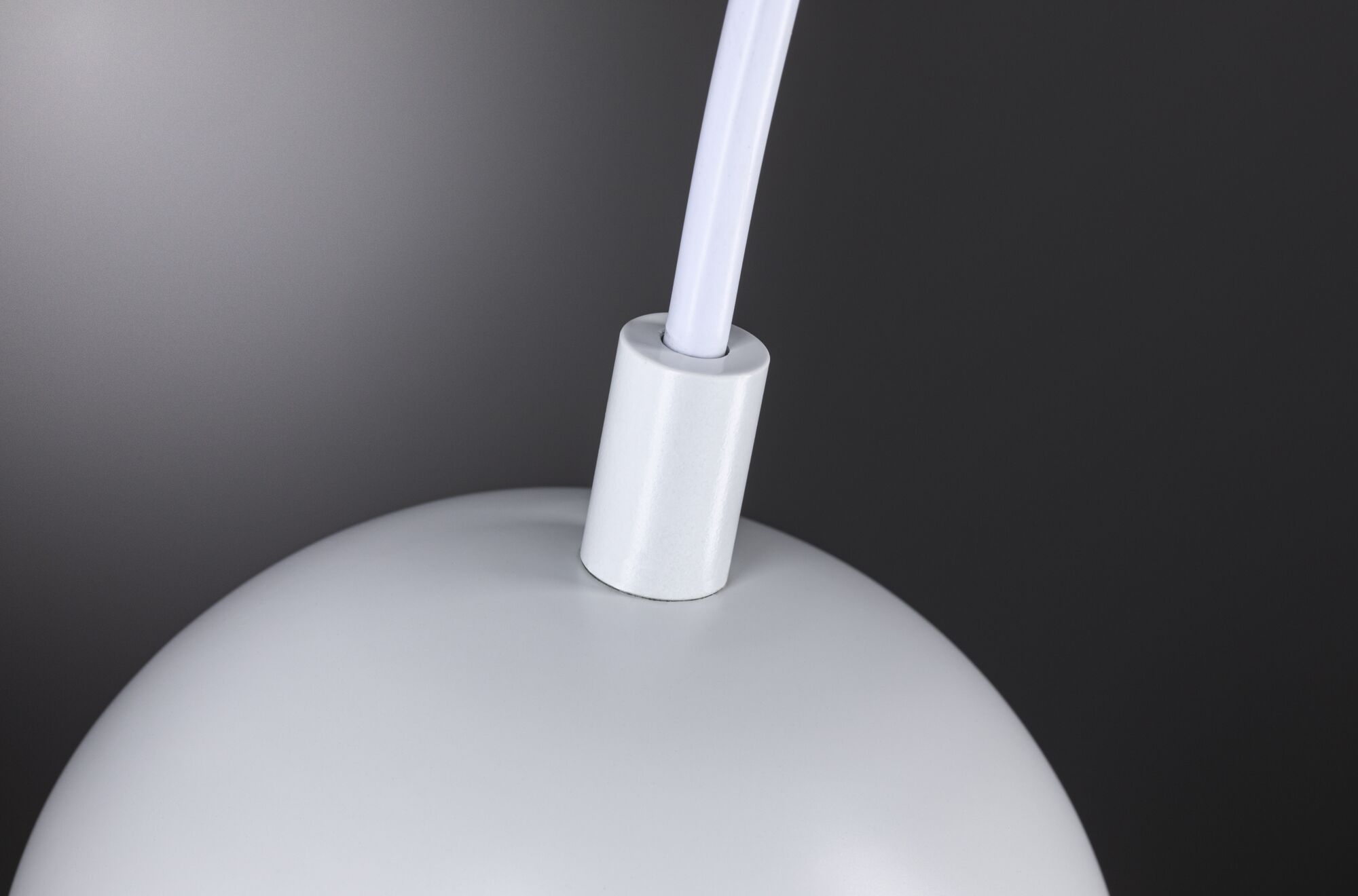 Close-up of white metal lampshade with white cable connection for LED lighting fixture