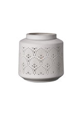 White ceramic lantern holder with delicate perforated patterns for ambient lighting
