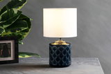 Table lamp with dark blue ceramic base and white fabric shade for elegant home lighting