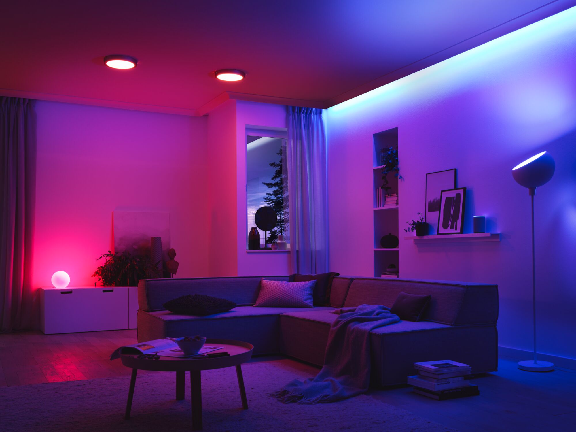 Modern living room with LED ceiling lights and colorful ambient lighting creating a cozy atmosphere.