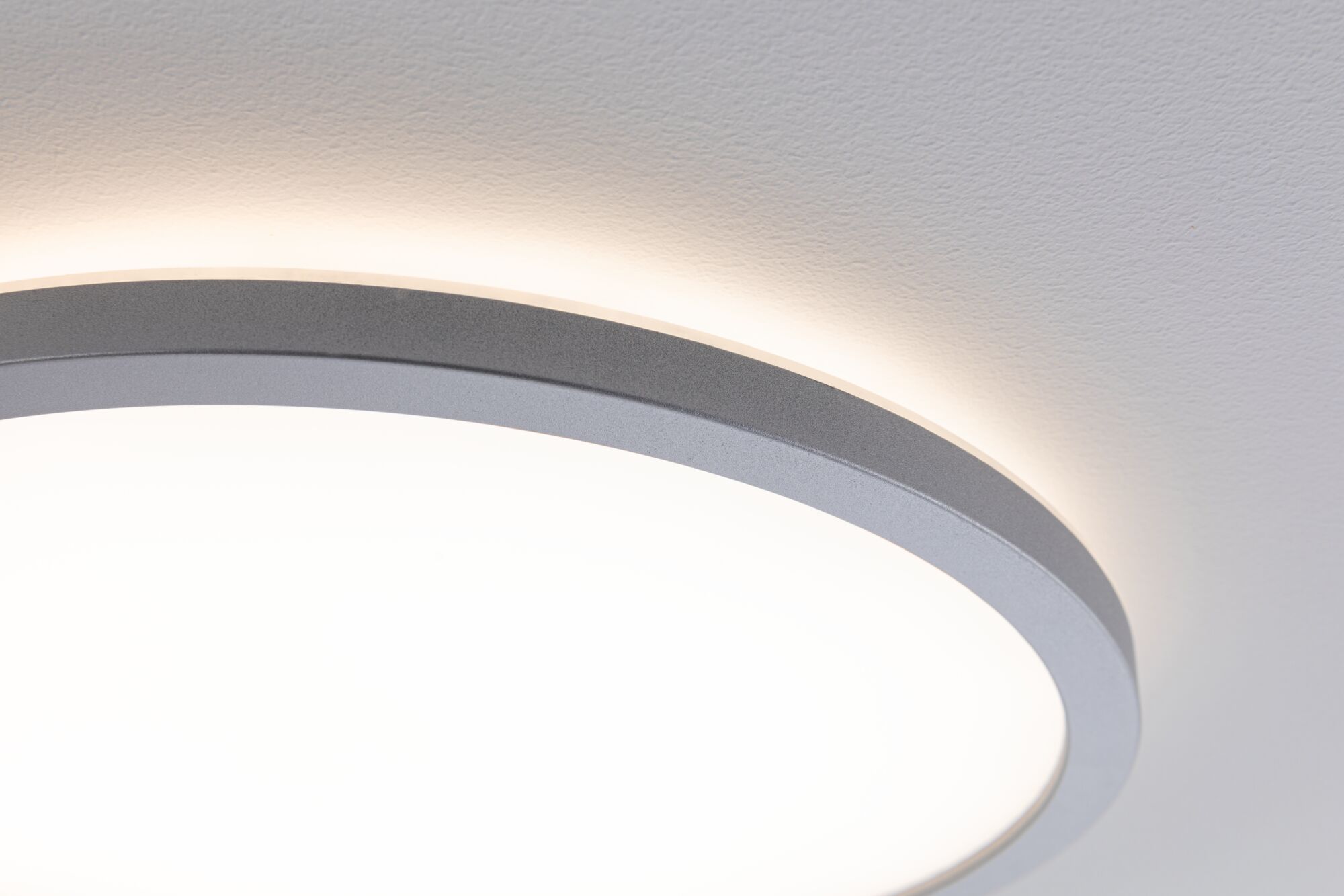 Round LED ceiling light with grey metal frame and warm white light for modern interiors